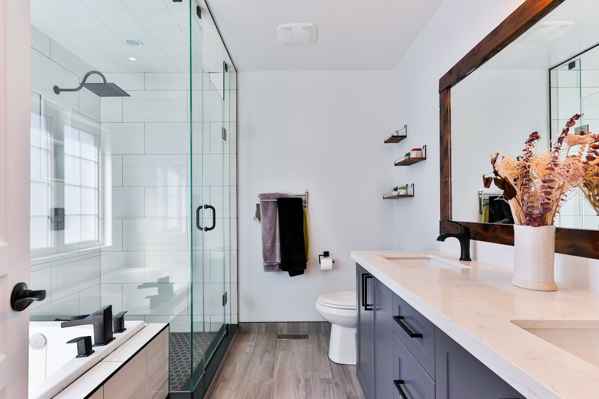 Modern bathroom with white subway tile shower and gray vanity